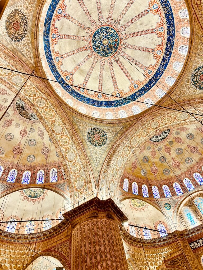 the ceiling of a large building with many windows