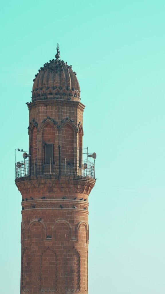 a tall tower with a clock on the top of it